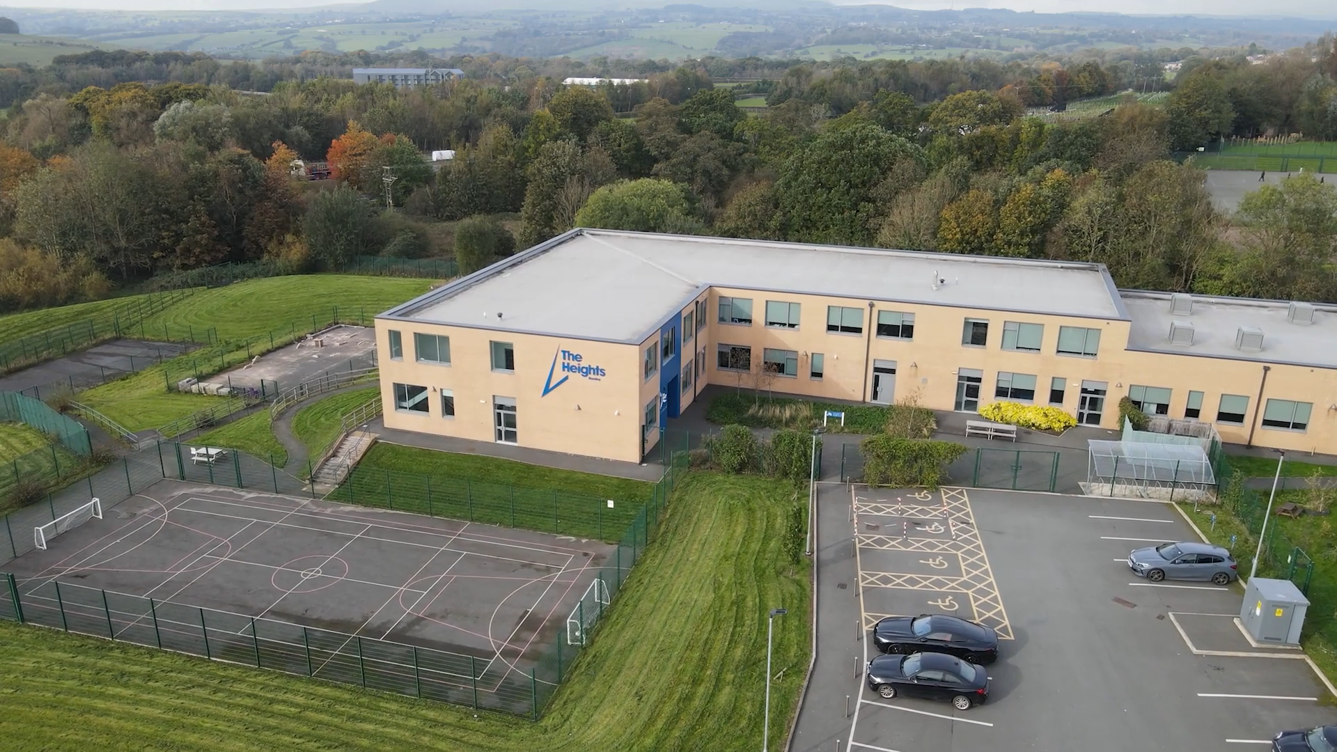 Aerial view of The Heights School, a modern building on the edge of Burnley, with the Forest of Bowland in the background.